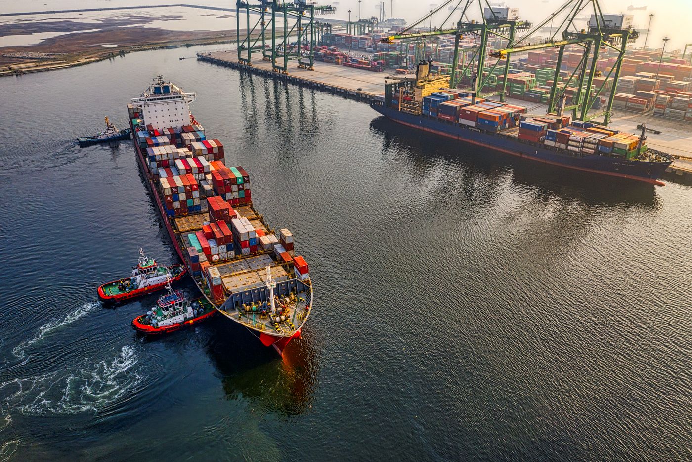 Gantry crane lifting containers at a marine terminal